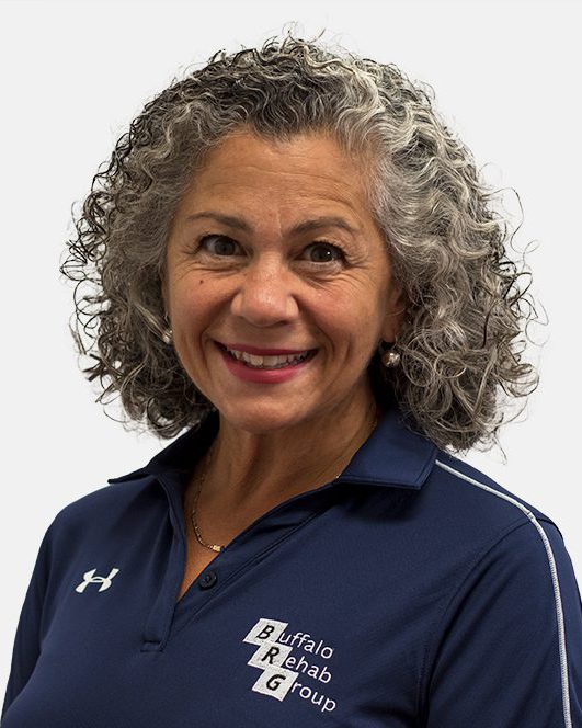 Portrait of a smiling Caucasian woman in a blue t-shirt.