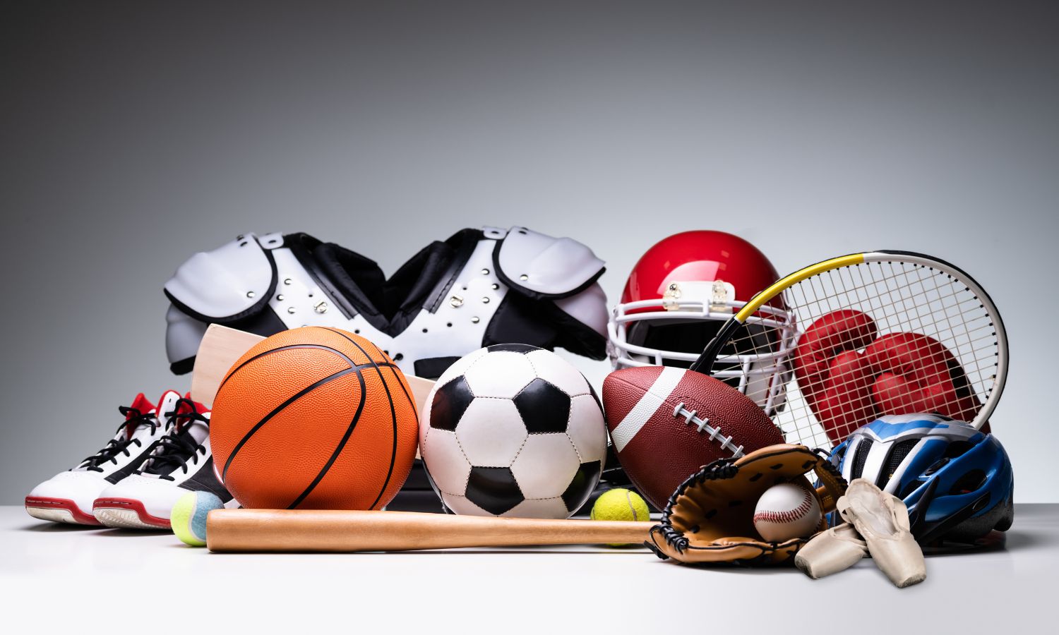 A physical therapist smiles as he converses with his patient.